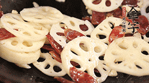 依次下香腸片、藕片翻炒均勻，加適量清水燜熟。