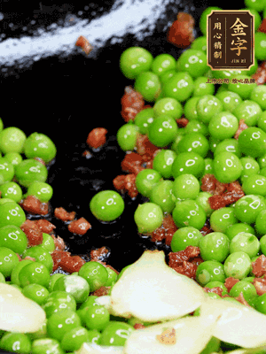 鍋內(nèi)少許油，下火腿煸香，再下甜豆米、百合翻炒，少許鹽、一點水煮到收干